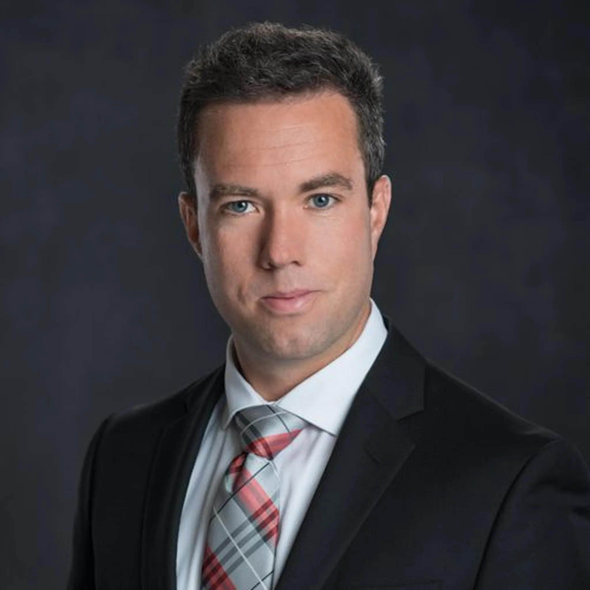 Ji's headshot, smiling with black tee