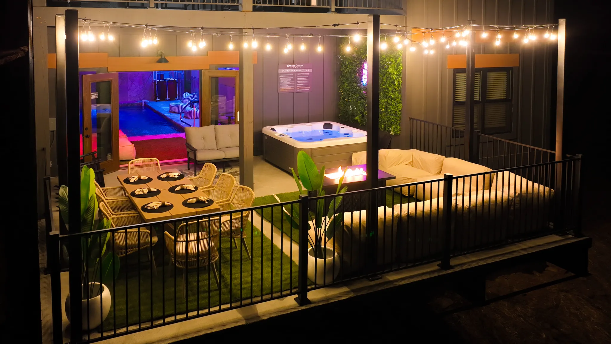 Back Patio with large sectional sofa, hot tub and a dining table