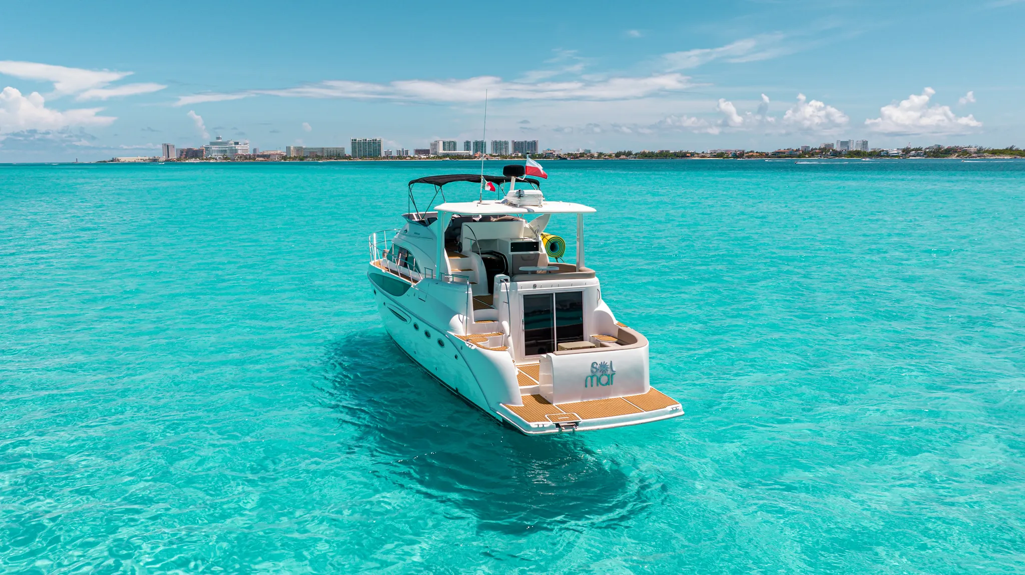 Luxury yacht cruising in turquoise waters in Isla Mujeres, exclusive experience with Solmar Rentals