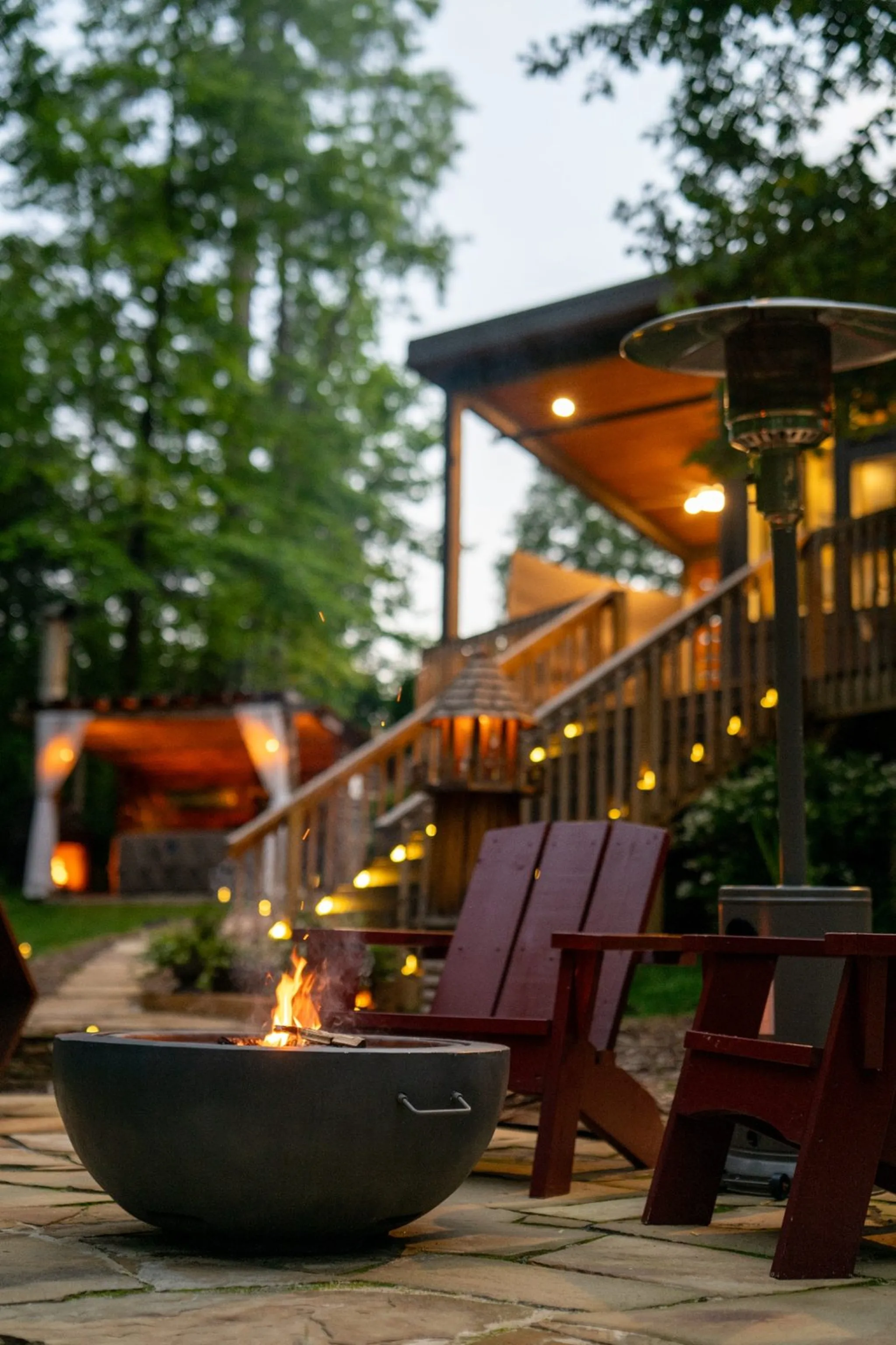 Fire pit at dusk with modern cabin and deck