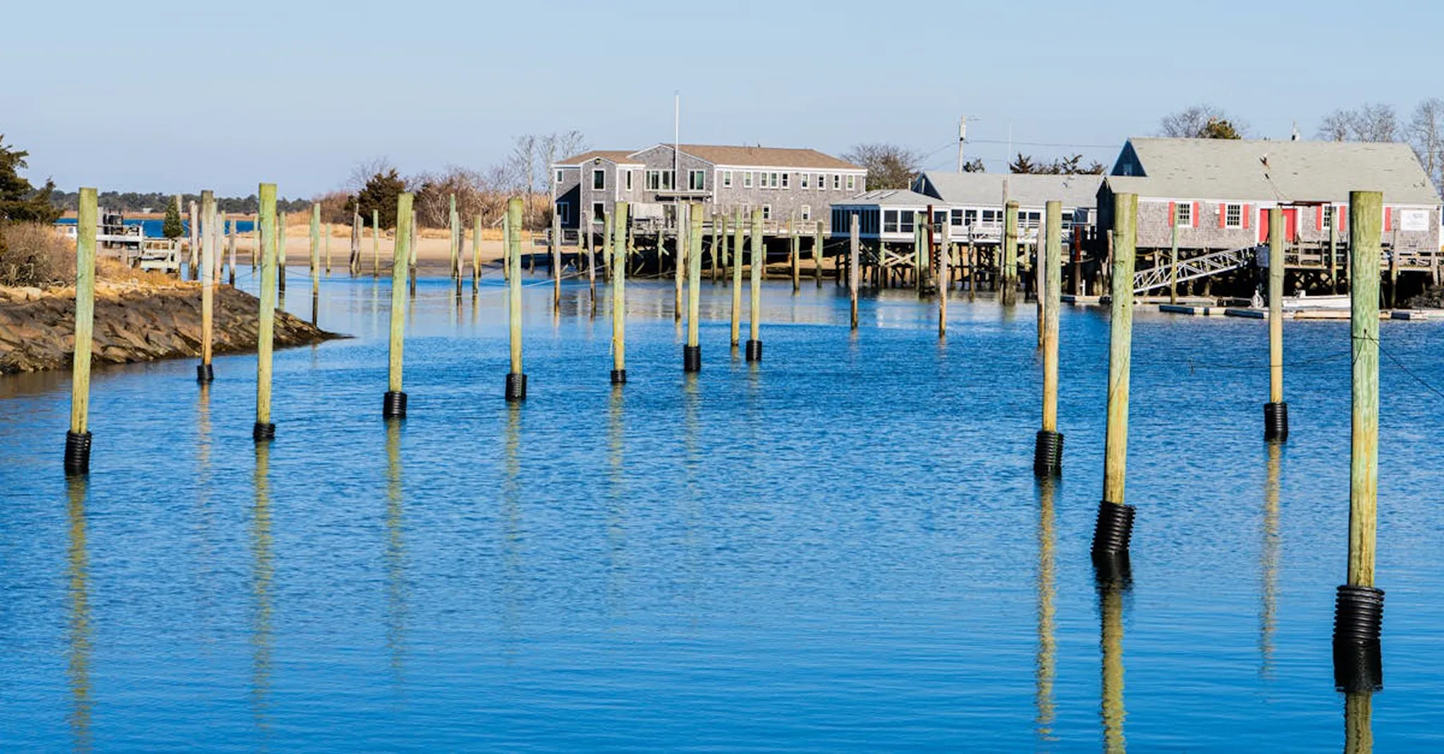Tranquil waterfront scene with piers and houses in Massachusetts, USA.